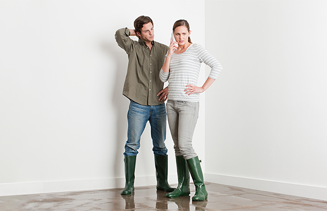 Couple evaluating flood in their home